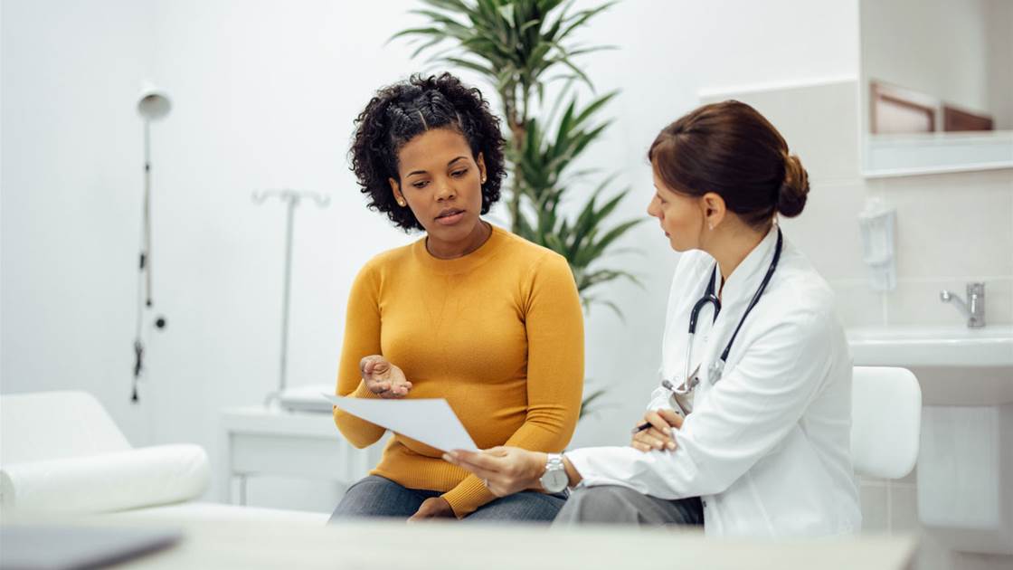 Woman speaking to a doctor about a women's health problem Woman speaking to a doctor about a women's health problem