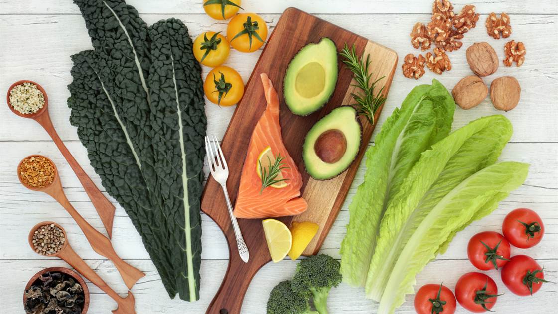 Fresh brain-healthy foods including salmon, avocado, leafy greens and nuts on a white wooden table Fresh brain-healthy foods including salmon, avocado, leafy greens and nuts on a white wooden table
