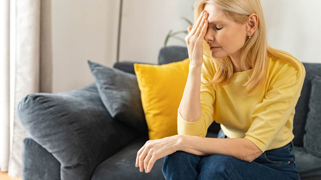 Woman with headache showing signs of possible nerve damage Woman with headache showing signs of possible nerve damage