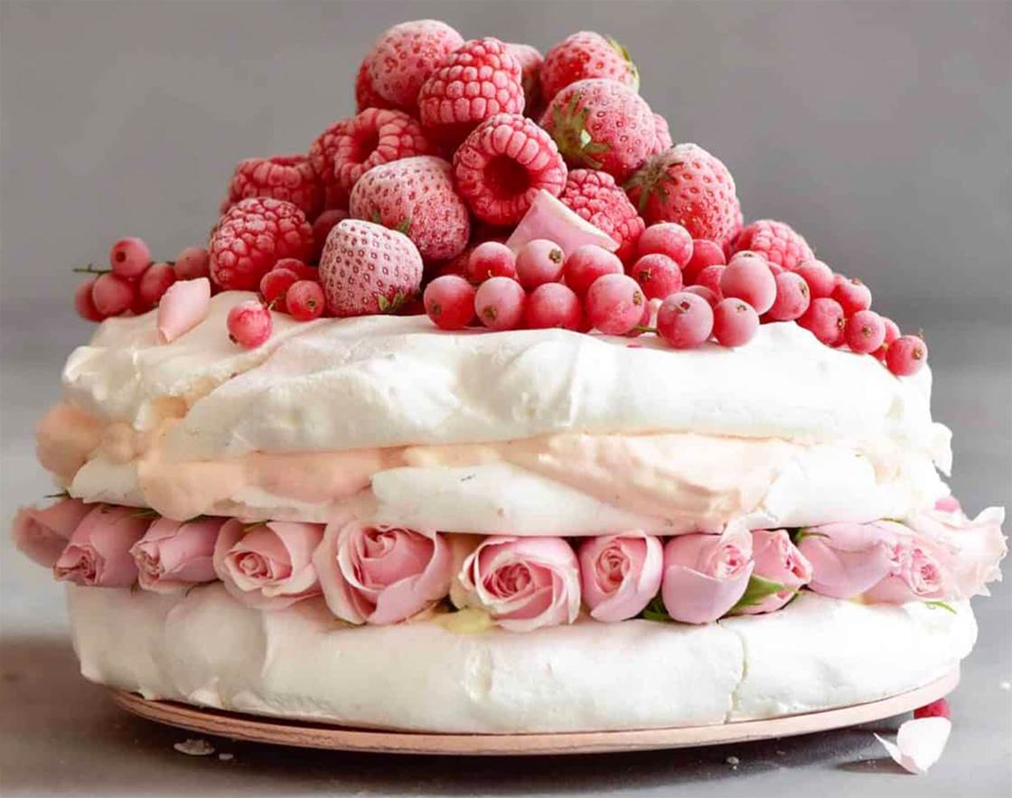pavlova cake with whipped coconut cream and berries