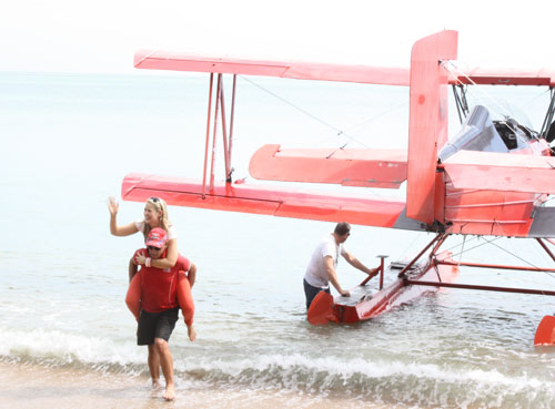 Candice gets a piggy-back from the sea plane!